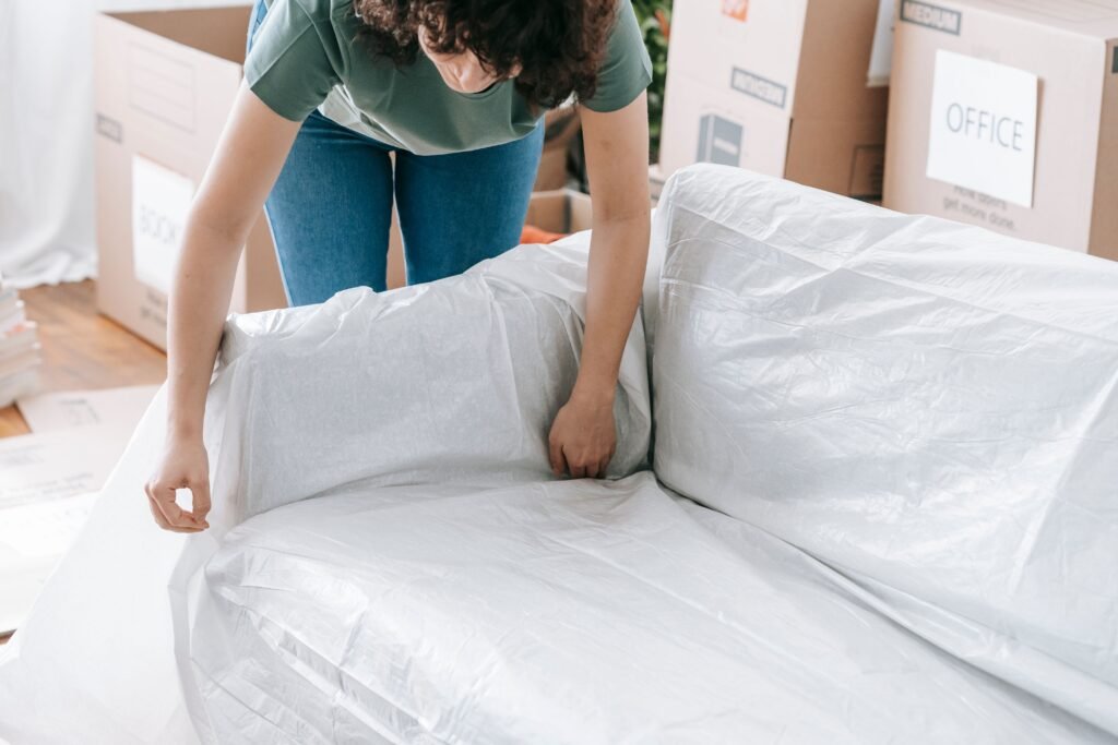 Occupied vs. Vacant (Move-In/Move-Out)  a lady covering sofa for move out 